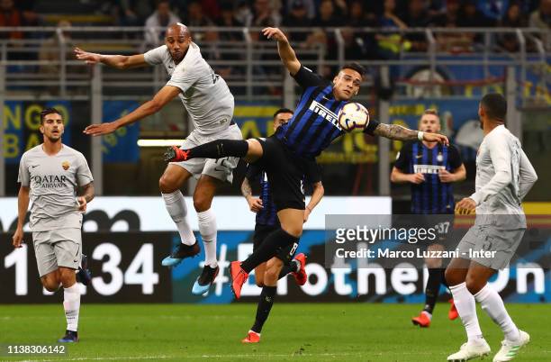 Lautaro Martinez of FC Internazionale competes for the ball with Steven Nzonzi of AS Roma during the Serie A match between FC Internazionale and AS...