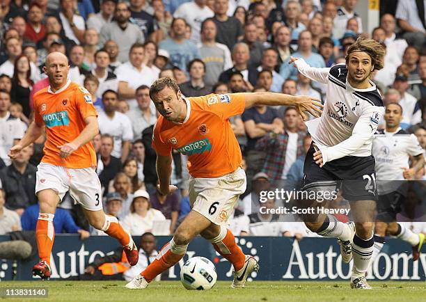 Ian Evatt of Blackpool shrugs off a challenge from Niko Kranjcar of Spurs during the Barclays Premier League match between Tottenham Hotspur and...