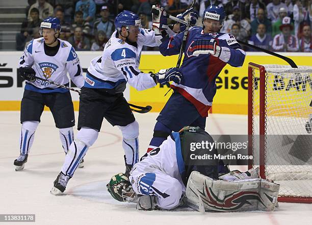 Ossi Vaananen of Finland hits Marcel Hossa of Slovakia with the stick battle for the puck during the IIHF World Championship qualification match...