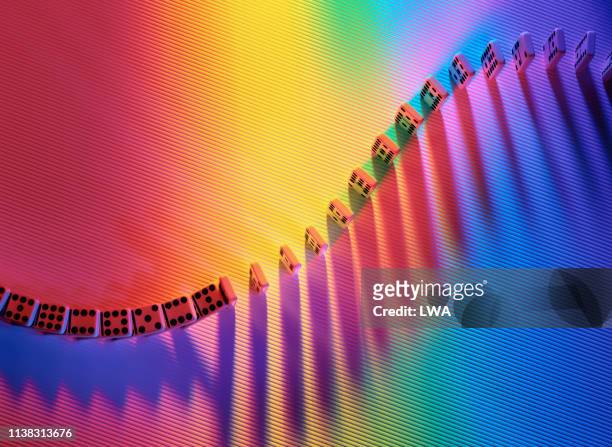 dominoes in coloured light - dominoes stock pictures, royalty-free photos & images