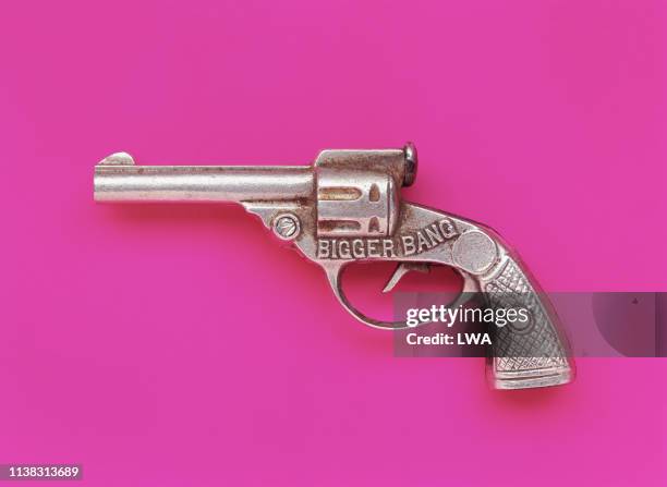 toy gun on pink background - toy gun stock pictures, royalty-free photos & images