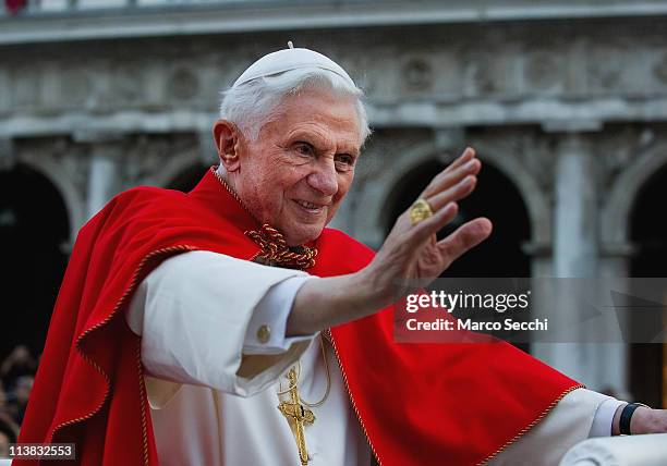 Pope Benedict XVI greets the crowd gathered in St Mark's Square while crossing the square on an electric car on May 7, 2011 in Venice, Italy. Pope...