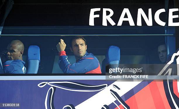France's players Eric Abidal, Marc Planus and Mathieu Valbuena are pictured on the team bus as it arrives at the Fields of Dreams stadium in Knysna...