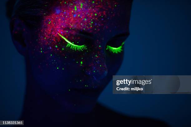 one woman painted with fluorescent make up - neon face paint stock pictures, royalty-free photos & images
