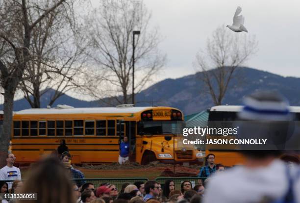 Dove flies over the crowd at the end of the Columbine Remembrance Ceremony at Clement Park in Littleton, Colorado, on April 2019. - 12 students and...