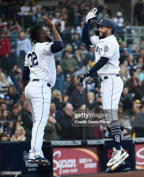 Eric Hosmer of the San Diego Padres, right, is congratulated by Franmil Reyes after hitting a solo home run during the second inning of a baseball...