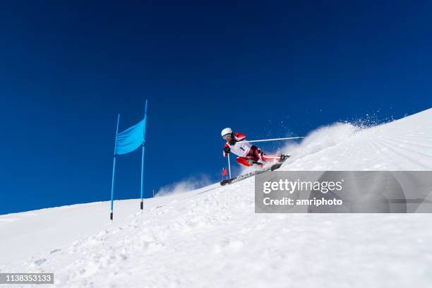 riesenslalom-skirennen ein männlicher skifahrer an blauer tür - slalom skiing stock-fotos und bilder