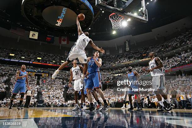 Sam Young of the Memphis Grizzlies dunks over Nick Collison of the Oklahoma City Thunder in Game Three of the Western Conference Semifinals in the...