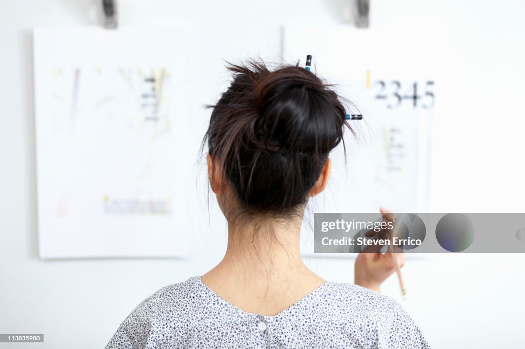 Young woman reviewing design mockups