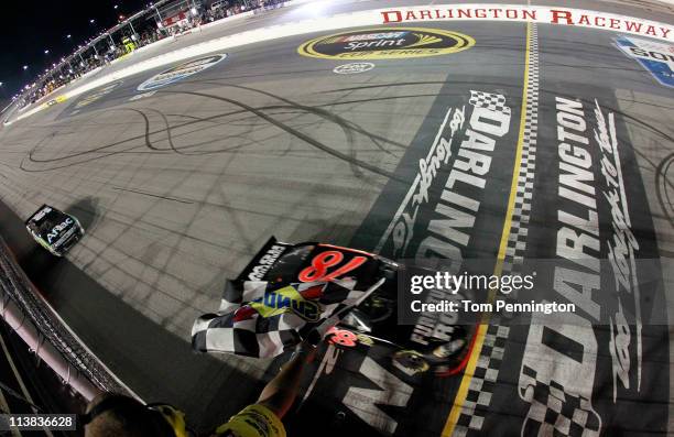 Regan Smith, driver of the Furniture Row Companies Chevrolet, crosses the finish line to win the NASCAR Sprint Cup Series SHOWTIME Southern 500 at...