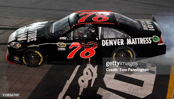 Regan Smith, driver of the Furniture Row Companies Chevrolet, performs a burnout to celebrate after winning the NASCAR Sprint Cup Series SHOWTIME...