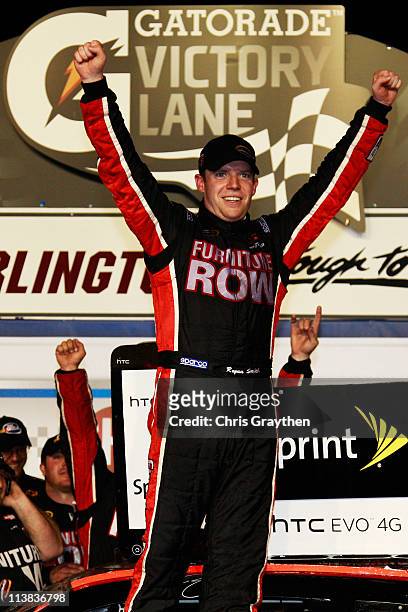 Regan Smith, driver of the Furniture Row Companies Chevrolet, celebrates in Victory Lane after winning the NASCAR Sprint Cup Series SHOWTIME Southern...