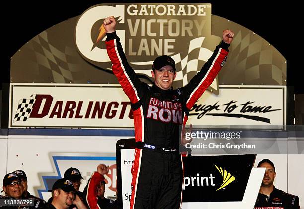 Regan Smith, driver of the Furniture Row Companies Chevrolet, celebrates in Victory Lane after winning the NASCAR Sprint Cup Series SHOWTIME Southern...