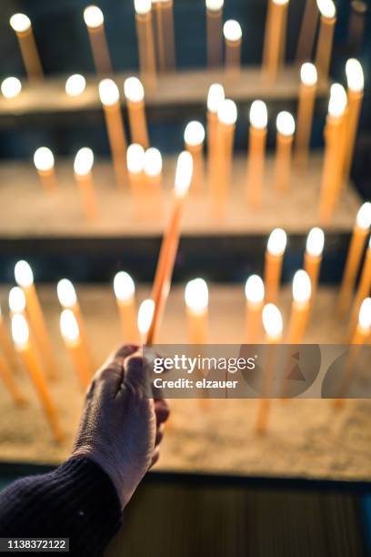 burning candle in bamberg cathedral - lighting candle stock pictures, royalty-free photos & images