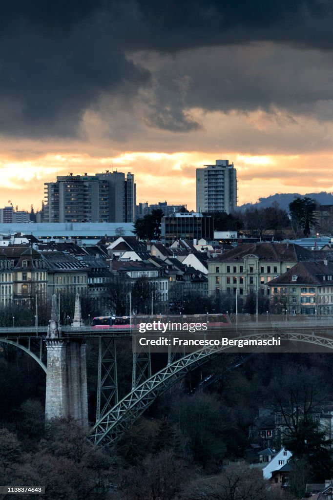 Bern Modern Red Tram Crosses The Bridge With Modern Buildings In The Background ...