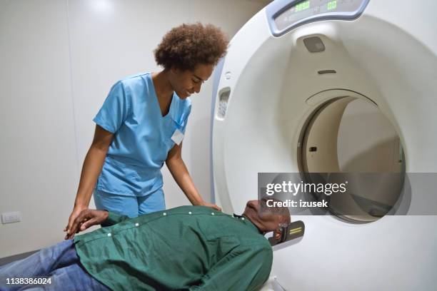 female nurse preparing for cat scan of patient - radiotherapy stock pictures, royalty-free photos & images