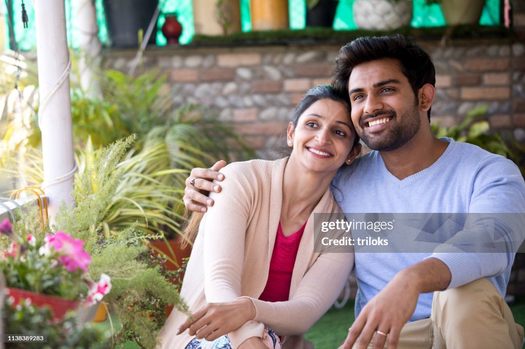 Indian couple sitting on porch