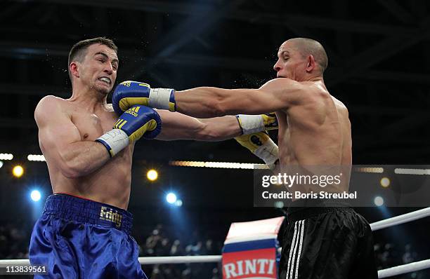 Eduard Gutknecht of Germany and Danny McIntosh of Great Britain exchange punches during their European Light Heavyweight title fight at...