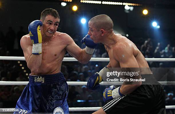 Eduard Gutknecht of Germany and Danny McIntosh of Great Britain exchange punches during their European Light Heavyweight title fight at...