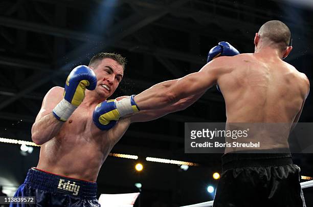 Eduard Gutknecht of Germany and Danny McIntosh of Great Britain exchange punches during their European Light Heavyweight title fight at...