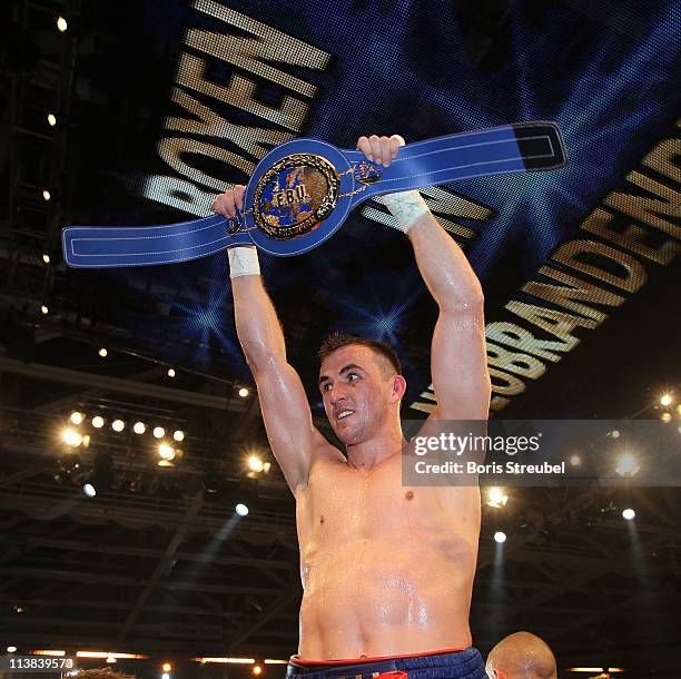 Eduard Gutknecht of Germany celebrates after winning the European Light Heavyweight title fight vs. Danny McIntosh of Great Britain at Jahnsportforum...