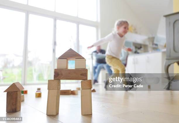 family at home, child playing with building blocks - girls modern room stock-fotos und bilder
