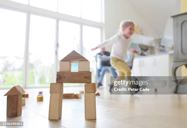 family at home, child playing with building blocks - girls modern room foto e immagini stock