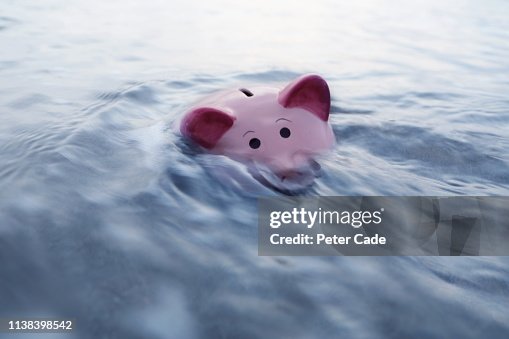 Piggy bank sinking in water Piggy bank sinking in water