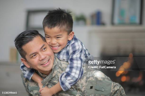 hugging dad - armed forces military family stock pictures, royalty-free photos & images