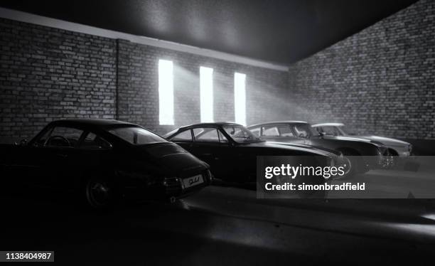 garage of dream car (models) - aston martin stock-fotos und bilder