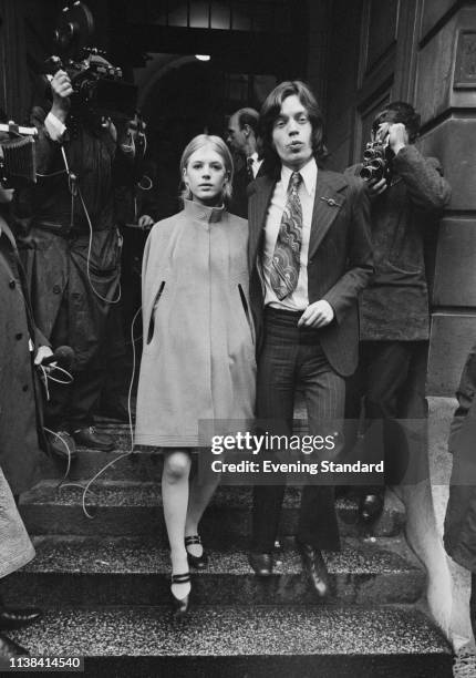 English singer, songwriter and actress Marianne Faithfull and English singer, songwriter, actor and film producer Mick Jagger leaving Marlborough...