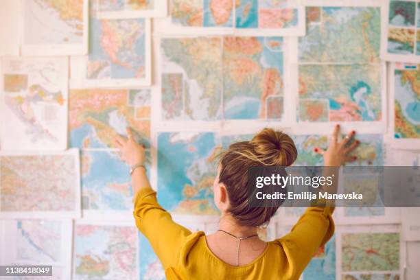 young woman looking at map - guia turistico fotografías e imágenes de stock
