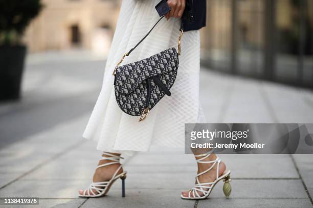 Füsun Lindner wearing Nobi Talai dress and earring, Dior bag and Jacquemus shoes on March 24, 2019 in Munich, Germany.