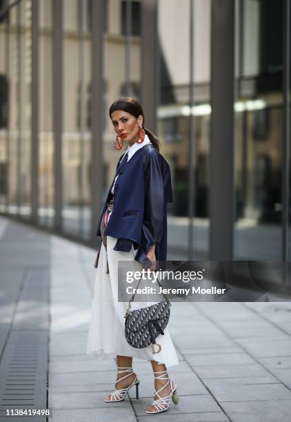 Füsun Lindner wearing Nobi Talai dress and earring, Dior bag and Jacquemus shoes on March 24, 2019 in Munich, Germany.