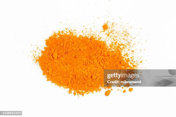 orange piles of pigment powder - vernice in polvere foto e immagini stock