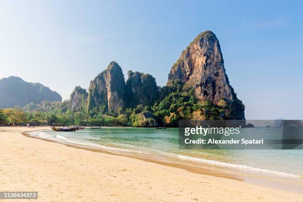 railay west beach surrounded by mountains, krabi province, thailand - tropical climate stock pictures, royalty-free photos & images