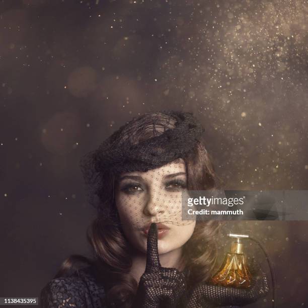retro woman with magical perfume - retro hairstyle stock pictures, royalty-free photos & images