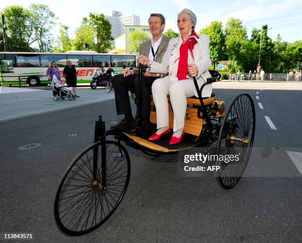 Jutta Benz , granddaughter of Bertha Benz, steers a "Benz Patent-Motorwagen" with Thomas Weber, board member of Daimler, during a rally to celebrate...