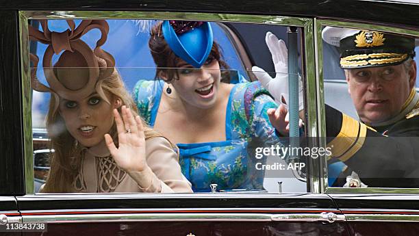 Britain's Prince Andrew, the Duke of York, and his daughters princesses Beatrice and Eugenie wave as they travel along the Processional Route to...