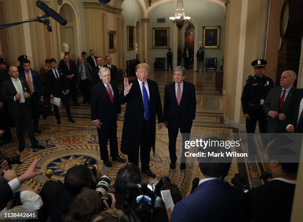 President Donald Trump walks with Senate Majority Leader Mitch McConnell , and Sen. Roy Blunt after arriving at a Senate Republican weekly policy...