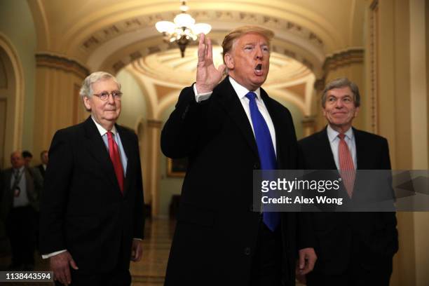 President Donald Trump speaks to members of the media as Senate Majority Leader Sen. Mitch McConnell , and Sen. Roy Blunt look on after he arrived at...
