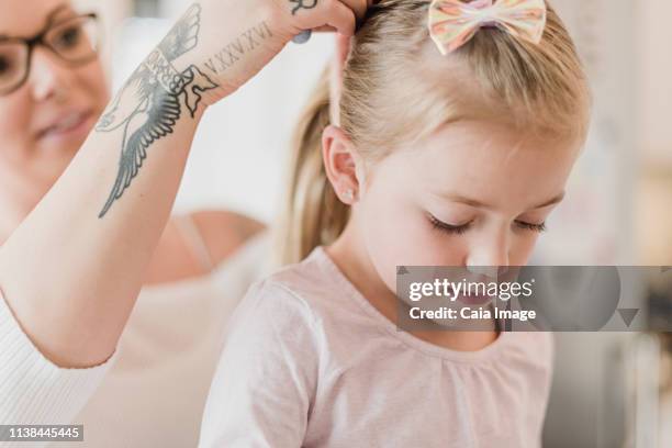 mother with tattoos fixing daughterõs hair - adjusting hair stock pictures, royalty-free photos & images