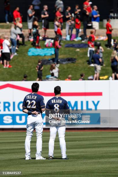 Ryan Braun of the Milwaukee Brewers and Christian Yelich stand for the playing of the National Anthem before the Spring Training game against the...