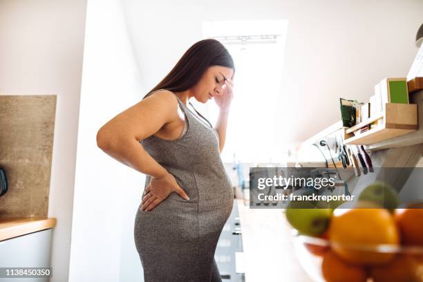 pregnant woman have a pain standing - pregnant imagens e fotografias de stock