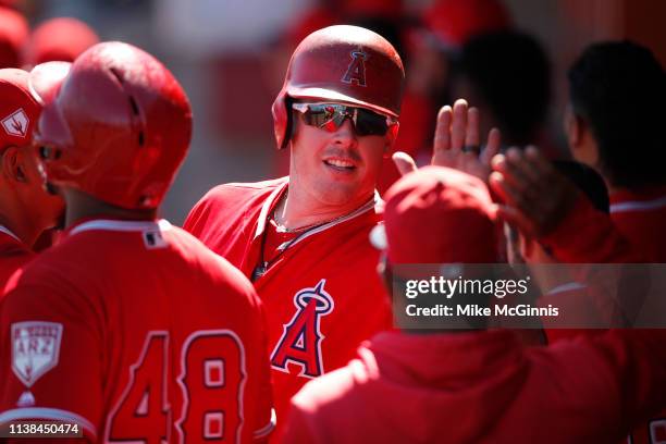 Justin Bour of the Angels of Anaheim celebrates in the dugout after hitting a home run during the Spring Training game against the Milwaukee Brewers...