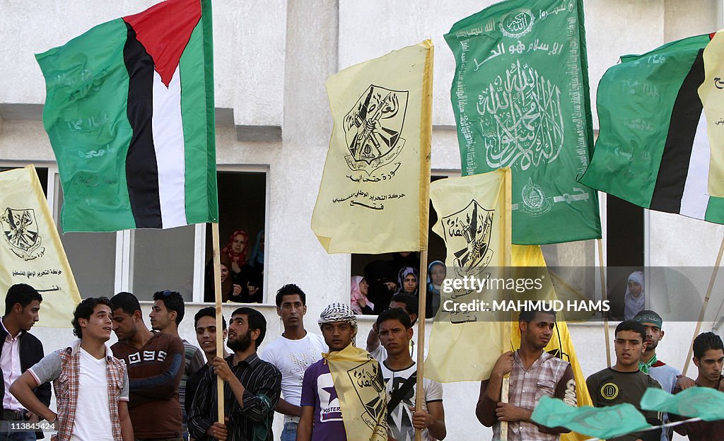 Palestinian students wave the flags of t