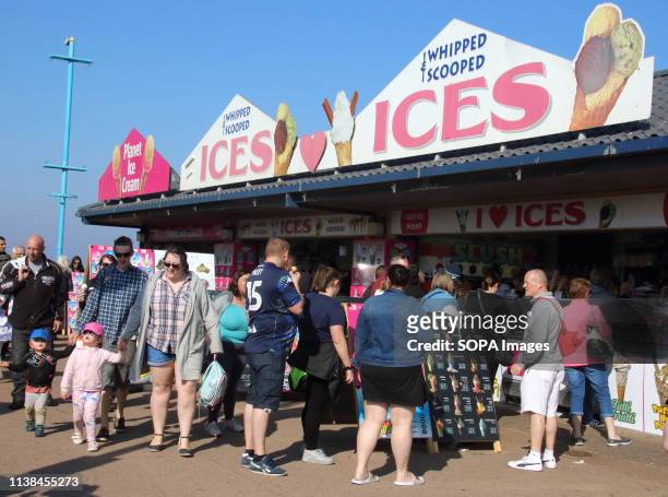 People seen queuing for ice creams and other refreshments at one of the many seafront kiosks during Easter. People enjoy the unseasonably warm Easter...