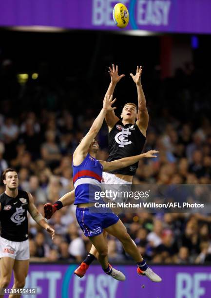 Liam Jones of the Blues takes a high mark over Josh Dunkley of the Bulldogs during the 2019 AFL round 05 match between the Western Bulldogs and the...
