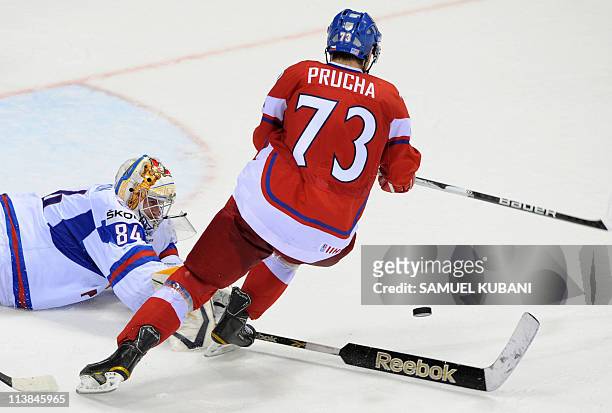 Petr Prucha of the Czech Republic fights for a puck with Konstantin Barulin of Russia during the IIHF Ice Hockey World Championship Qualification...