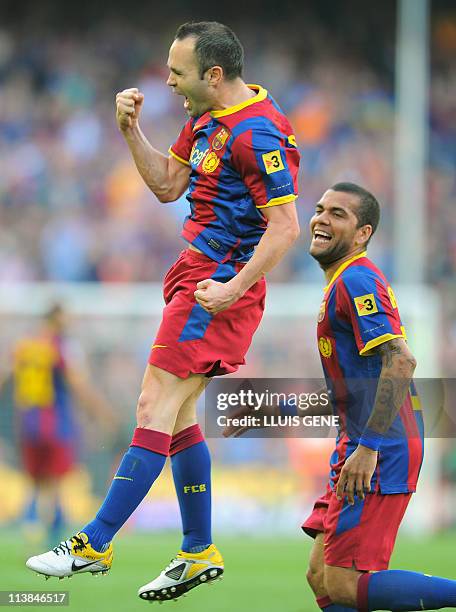 Barcelona's midfielder Andres Iniesta and Barcelona's Brazilian defender Dani Alves celebrate after scoring a goal during the Spanish League football...